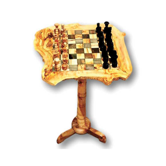 A handmade olive wood chess set displayed on a wooden table with a visible grain, set against a white background.
