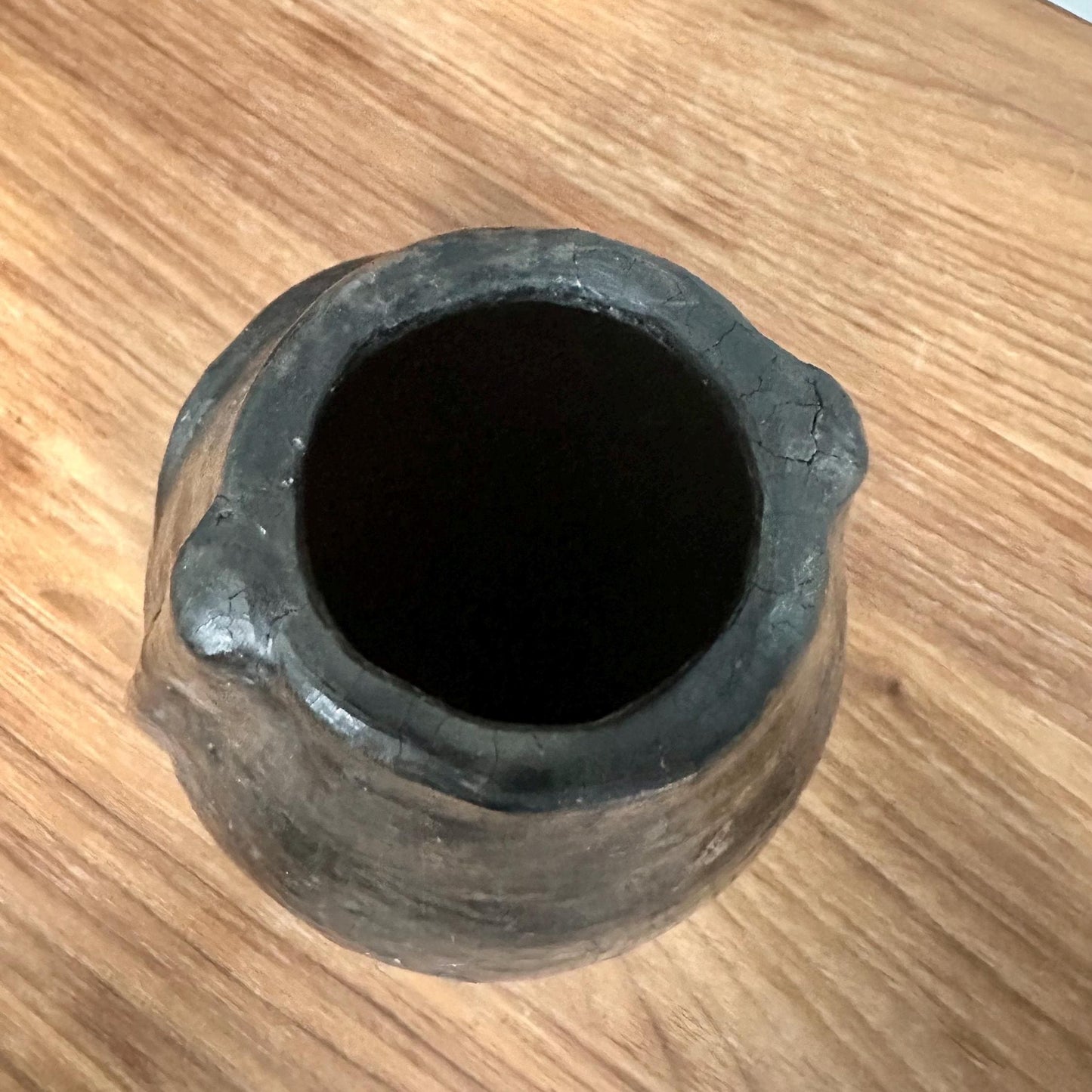 Black pot on a wooden surface