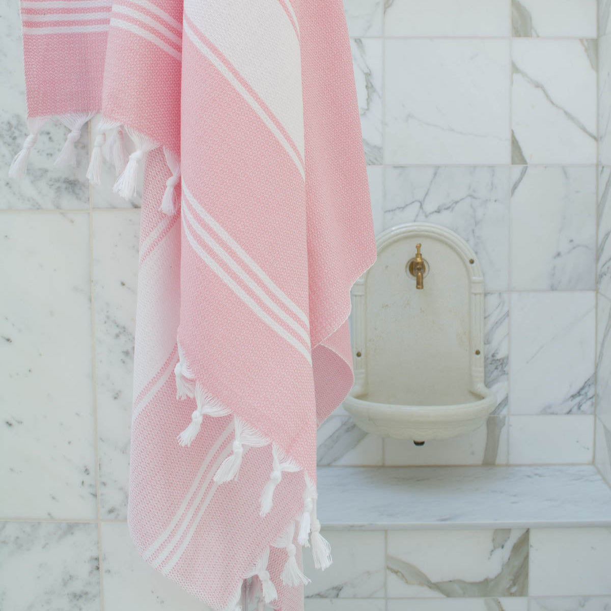 pink fouta turkish style towel drapped on a  wall in a hammam or spa