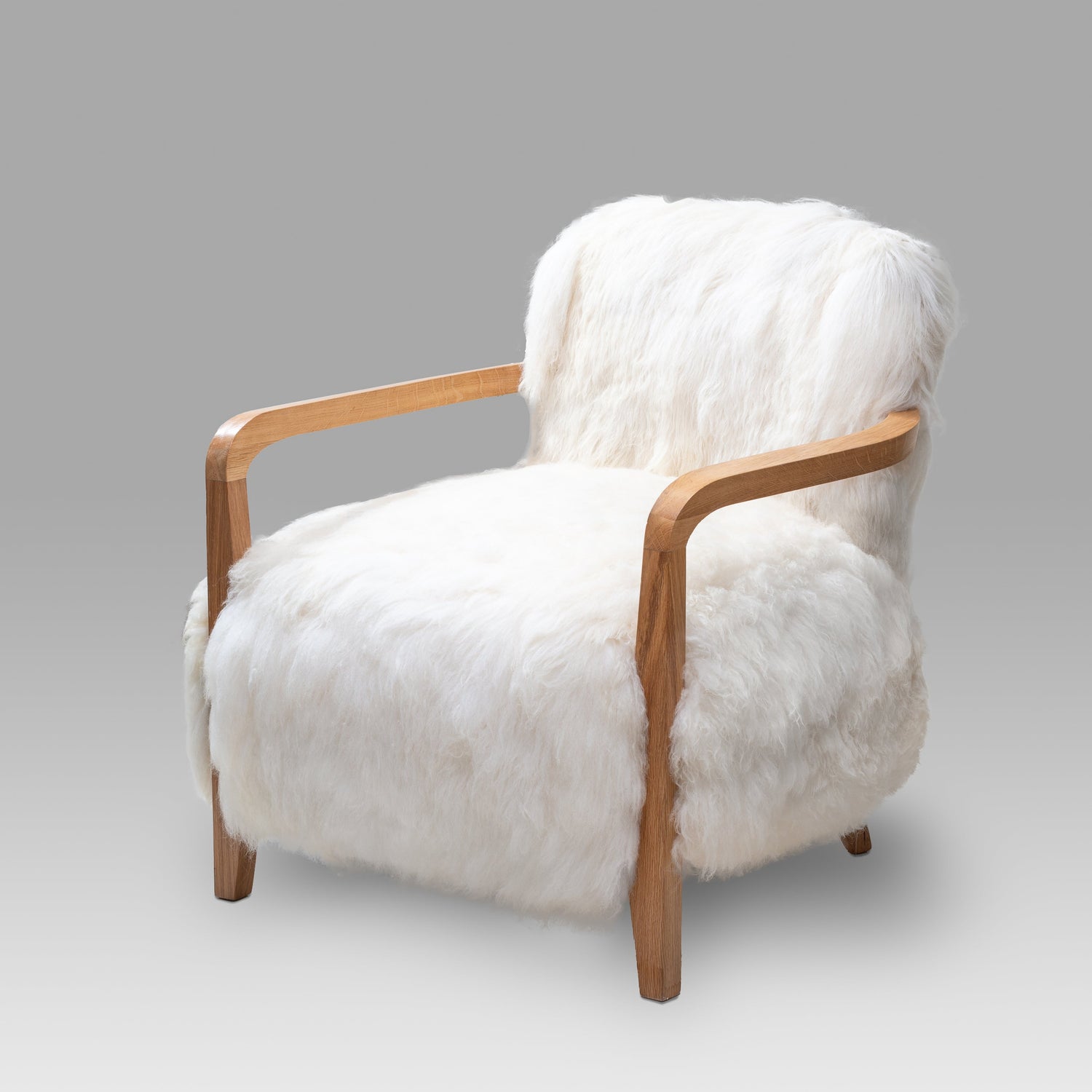 A luxury handcrafted wooden arm chair upholstered in soft genuine lambskin, with a solid wooden frame and visible armrests.