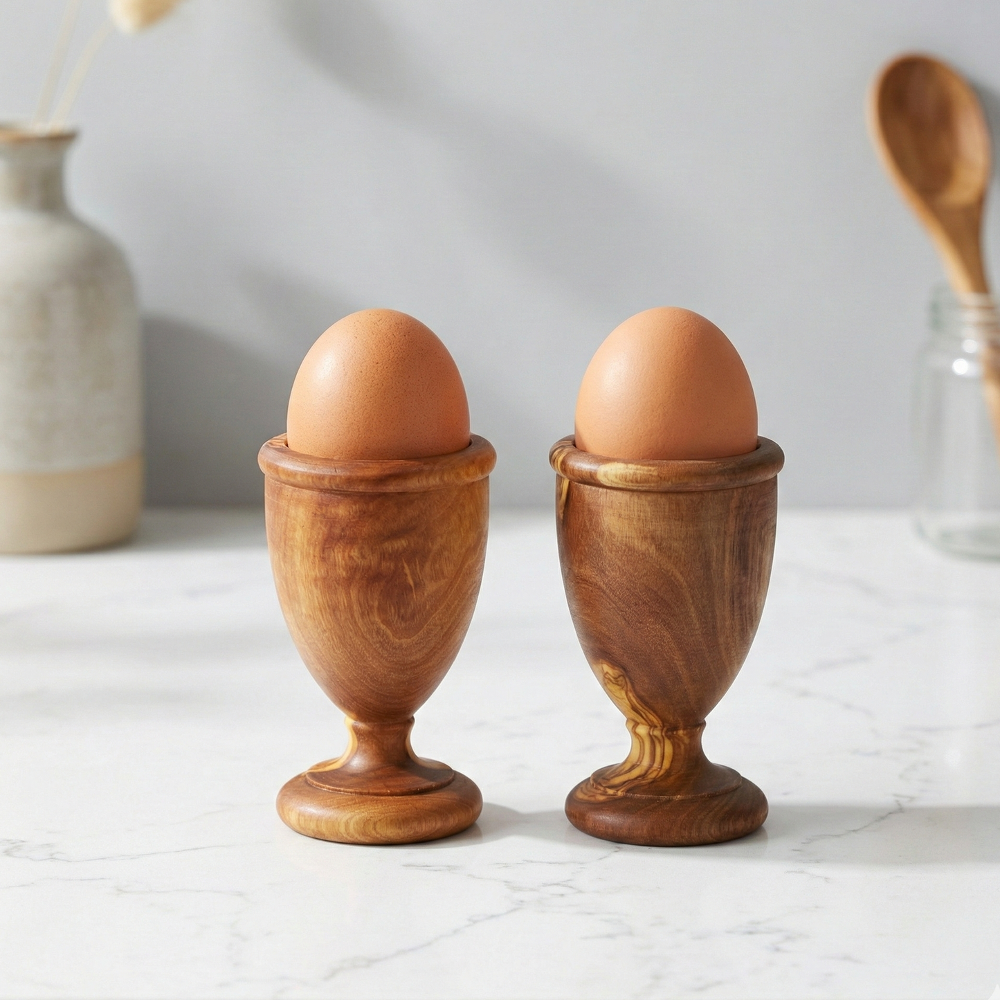 Handmade olive wood egg holders, set of 2, crafted from natural olive wood with unique wood grain.