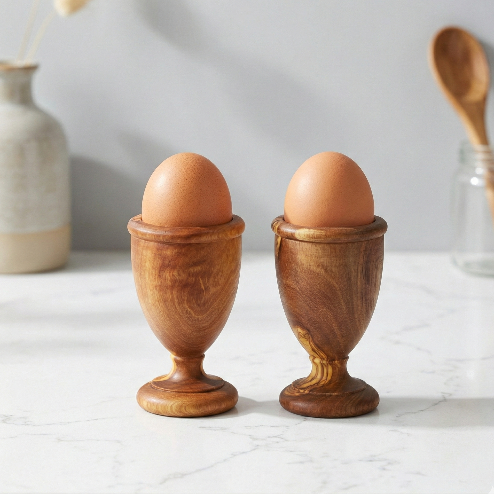 Handmade olive wood egg holders, set of 2, crafted from natural olive wood with unique wood grain.