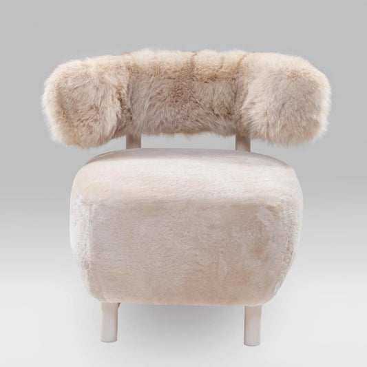 Handmade shaved lambskin and vintage fox fur chair with a solid natural wood frame, combining artisan craftsmanship and luxurious comfort.