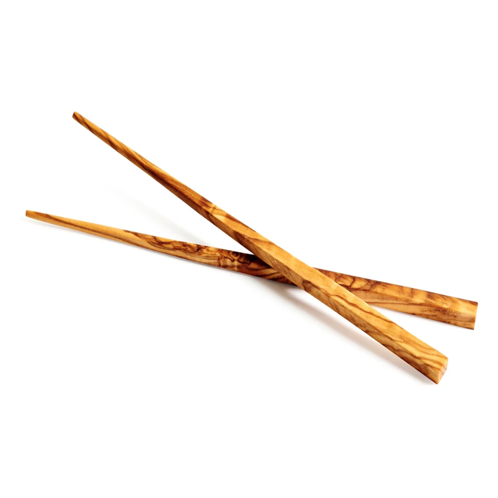 A pair of handmade olive wood chopsticks placed on a white background.