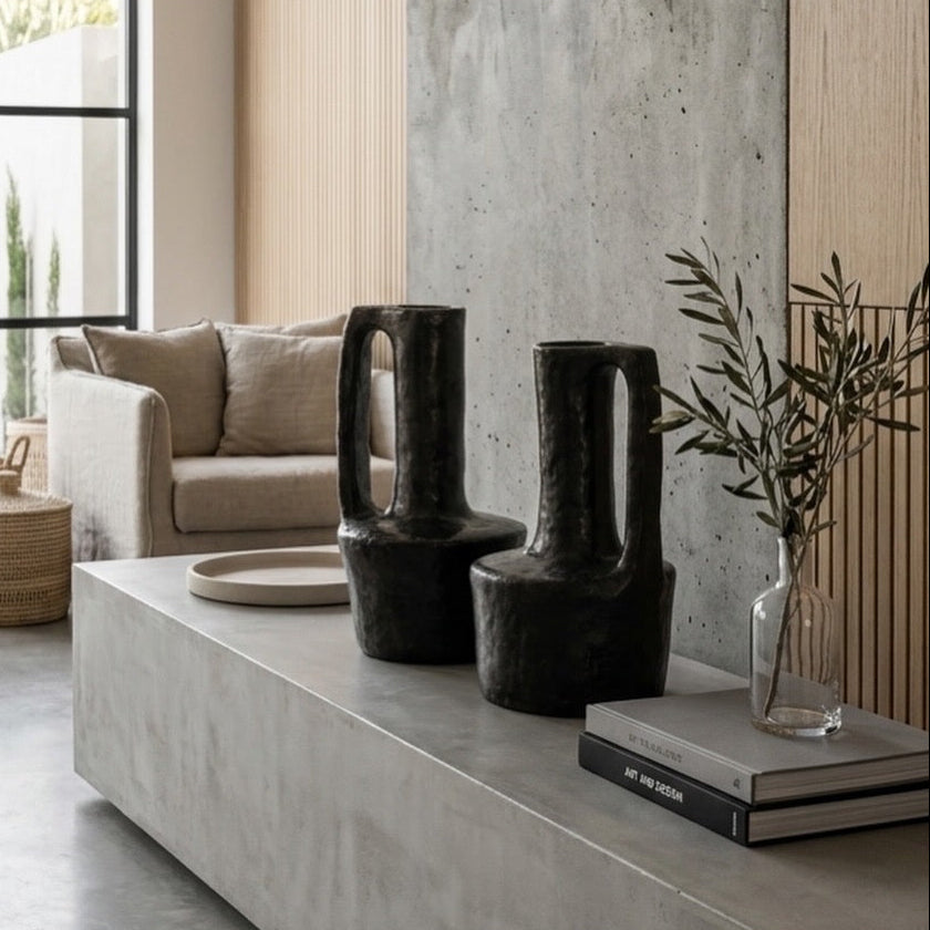 two sejnane handle vase pettery placed on a living room table.